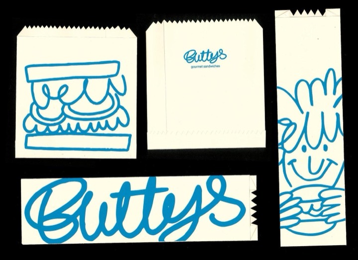 Sandwich shop identity doing everything with one blue ink on plain paper bags, brush script plus loose marker doodles at wildly different scales.