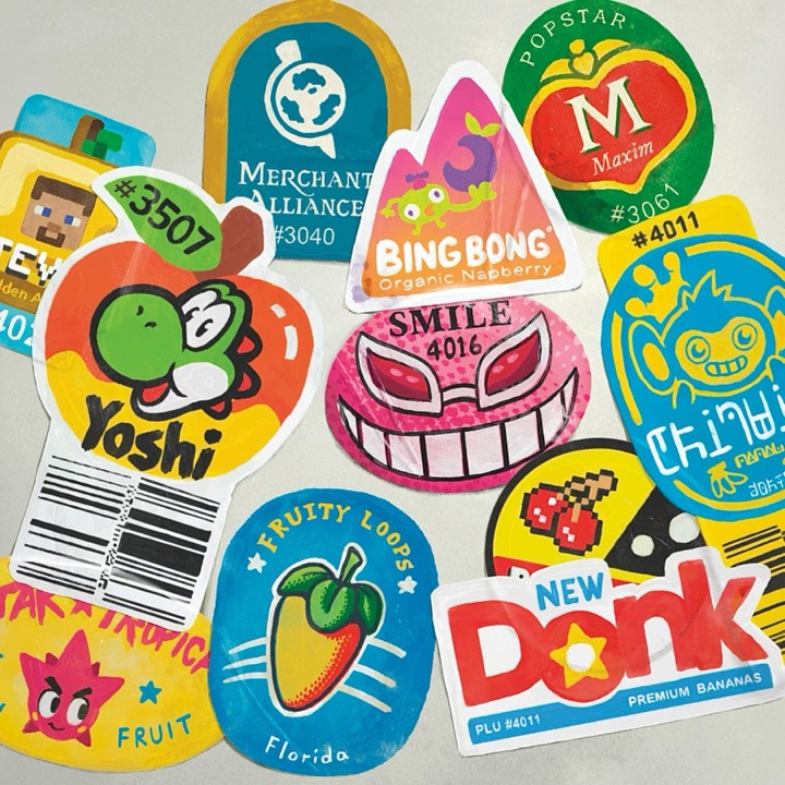 Hand-painted fake fruit PLU stickers riffing on game and software brands, a masterclass in cramming a logo into an odd die-cut shape.