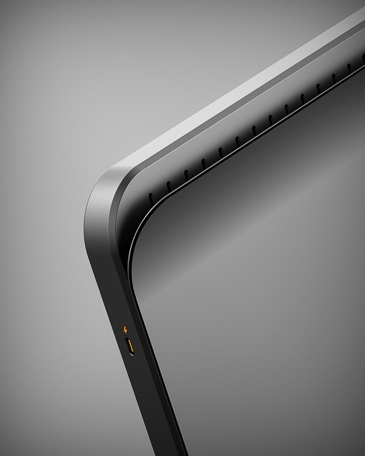 Monochrome device render where the only color is a tiny orange USB-C port, a lesson in one accent doing all the work.